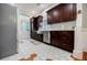Modern kitchen featuring dark wood cabinets, stainless steel appliances, and hexagonal tile flooring at 549 Atwood Sw St, Atlanta, GA 30310