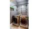 Functional laundry room showcasing a modern washer and dryer set with convenient shelving at 549 Atwood Sw St, Atlanta, GA 30310