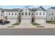 Charming townhomes with brick and white siding and individual one car garages at 903 Eagle Ave, Riverdale, GA 30296