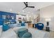 Open floor plan with blue accent wall, kitchen, and living area featuring a modern ceiling fan at 903 Eagle Ave, Riverdale, GA 30296