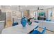 Open concept kitchen and living room with view of staircase and television set up at 903 Eagle Ave, Riverdale, GA 30296