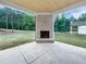 This lovely back patio has a stunning view and brick fireplace at 1465 Leach Dr, Lawrenceville, GA 30045