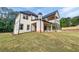 Rear view of the home showcasing large windows, balcony, and sprawling green lawn at 1465 Leach Dr, Lawrenceville, GA 30045