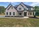 Charming two-story home featuring a stone and brick facade with black trim accents at 1465 Leach Dr, Lawrenceville, GA 30045