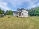 Front view of a home featuring beautiful landscaping and a well-manicured lawn at 1465 Leach Dr, Lawrenceville, GA 30045
