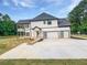 View of home's side and garage, showing a modern entrance with multi-panel doors at 1465 Leach Dr, Lawrenceville, GA 30045
