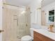 Updated bathroom featuring a tiled shower with glass doors, modern fixtures, and a vanity at 2110 Argyle Se Dr, Smyrna, GA 30080