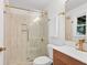 Modern bathroom with a glass shower, a wood vanity with a white sink, and gold fixtures at 2110 Argyle Se Dr, Smyrna, GA 30080