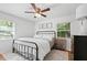Bright bedroom with a black metal bed frame, natural light, and hardwood floors at 2110 Argyle Se Dr, Smyrna, GA 30080
