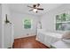 Cozy bedroom with hardwood floors, two windows, and a ceiling fan that offers natural light at 2110 Argyle Se Dr, Smyrna, GA 30080