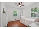 Bedroom with hardwood floors, a white bed frame, and natural light streaming through the window at 2110 Argyle Se Dr, Smyrna, GA 30080