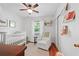 Bright Bedroom with hardwood floors, white crib, white chair and ceiling fan at 2110 Argyle Se Dr, Smyrna, GA 30080