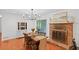 Cozy dining room with hardwood floors, a brick fireplace, and a view of the backyard at 2110 Argyle Se Dr, Smyrna, GA 30080