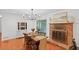 Bright dining area features an elegant chandelier, a brick fireplace, and hardwood floors at 2110 Argyle Se Dr, Smyrna, GA 30080