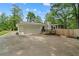 Rear exterior of house with driveway, two car garage, deck and fenced in back yard at 2110 Argyle Se Dr, Smyrna, GA 30080