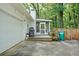 View of garage, wooden deck, grill, screened porch, and wooded yard at 2110 Argyle Se Dr, Smyrna, GA 30080