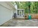 Exterior view of home with a deck, grill, fenced yard, and a two-car garage at 2110 Argyle Se Dr, Smyrna, GA 30080