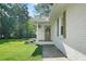 Close up view of the painted brick front entrance of this home with a well manicured lawn and mature trees at 2110 Argyle Se Dr, Smyrna, GA 30080