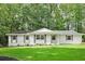 Charming white-brick single-story home with a well-manicured lawn, fresh landscaping and mature trees at 2110 Argyle Se Dr, Smyrna, GA 30080