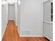 Long hallway featuring hardwood floors and neutral paint, creating a seamless flow throughout the home at 2110 Argyle Se Dr, Smyrna, GA 30080