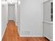 Hallway with hardwood floors, white walls, and a built-in cabinet on the right at 2110 Argyle Se Dr, Smyrna, GA 30080