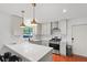 Modern kitchen with white cabinets, stainless steel appliances, and a breakfast bar at 2110 Argyle Se Dr, Smyrna, GA 30080