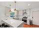 Modern kitchen with white countertops, stainless steel appliances, and updated lighting fixtures at 2110 Argyle Se Dr, Smyrna, GA 30080