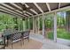Inviting screened porch featuring a dining area and peaceful views of the lush, green backyard at 2110 Argyle Se Dr, Smyrna, GA 30080