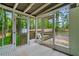 Charming screened porch with tiled floors offering backyard access to the deck and a storage shed at 2110 Argyle Se Dr, Smyrna, GA 30080