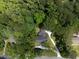 An aerial view shows a home surrounded by dense, mature trees and a winding driveway at 2719 Cravey Ne Dr, Atlanta, GA 30345