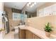 Traditional bathroom featuring tiled walls, vanity with sink, and window with blinds at 2719 Cravey Ne Dr, Atlanta, GA 30345