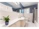 A cozy bathroom with white tile, a large mirror, and blue accents at 2719 Cravey Ne Dr, Atlanta, GA 30345