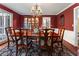 Elegant dining room with a wood table, chandelier, and floral rug creating a warm and inviting atmosphere at 2719 Cravey Ne Dr, Atlanta, GA 30345