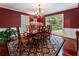 Elegant dining room featuring hardwood floors, a large window, and a stylish chandelier at 2719 Cravey Ne Dr, Atlanta, GA 30345