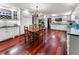 Open kitchen with white cabinets, granite countertops, stainless steel appliances, hardwood floors, and a breakfast table at 2719 Cravey Ne Dr, Atlanta, GA 30345