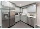 A modern kitchenette with stainless steel appliances and gray cabinets at 2719 Cravey Ne Dr, Atlanta, GA 30345
