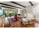 Bright living room with exposed beams, hardwood floors, comfortable seating, and access to the outdoor patio at 2719 Cravey Ne Dr, Atlanta, GA 30345
