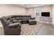 A cozy living room features a large sectional sofa, a TV, and a decorative rug at 2719 Cravey Ne Dr, Atlanta, GA 30345
