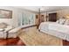Spacious main bedroom featuring a four-poster bed, hardwood floors, and a cozy sitting area at 2719 Cravey Ne Dr, Atlanta, GA 30345