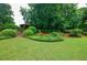 Expansive backyard with lush landscaping, manicured lawn, and a charming gazebo at 5318 Brooke Farm Dr, Dunwoody, GA 30338