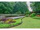 Secluded backyard featuring bocce ball court, gazebo, and meticulously landscaped grounds at 5318 Brooke Farm Dr, Dunwoody, GA 30338