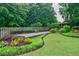 Landscaped backyard with a gazebo and manicured lawn at 5318 Brooke Farm Dr, Dunwoody, GA 30338