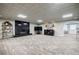 Spacious basement with fireplace, entertainment area, and neutral-toned carpet at 5318 Brooke Farm Dr, Dunwoody, GA 30338