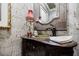 Charming powder room with decorative mirror, patterned wallpaper, and antique vanity at 5318 Brooke Farm Dr, Dunwoody, GA 30338