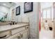 Stylish bathroom with unique wallpaper, black and white tile floor, and modern fixtures at 5318 Brooke Farm Dr, Dunwoody, GA 30338