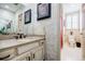 Bathroom featuring vintage style patterned wallpaper, a vanity with a sink, and a separate toilet room at 5318 Brooke Farm Dr, Dunwoody, GA 30338