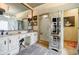 Bathroom with a double sink, vanity and large framed mirror at 5318 Brooke Farm Dr, Dunwoody, GA 30338