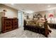 Finished basement bedroom featuring light carpet, neutral walls, and a decorative wrought iron bed at 5318 Brooke Farm Dr, Dunwoody, GA 30338