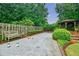 A luxurious bocce court is surrounded by manicured landscaping and a wooden fence at 5318 Brooke Farm Dr, Dunwoody, GA 30338