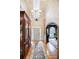 Grand foyer featuring hardwood floors, arched entryways, statement chandelier, and a decorative area rug at 5318 Brooke Farm Dr, Dunwoody, GA 30338